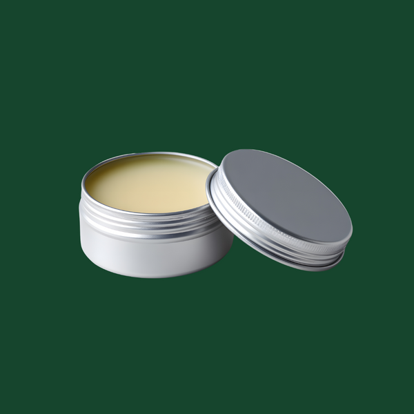 Open silver tin with a yellowish beard balm cream inside on a green background